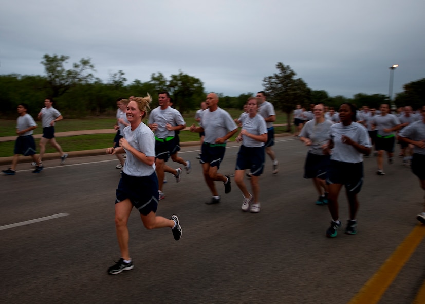 Airmen participate in a squadron run Sept. 28, 2012, as part of Comprehensive Airmen Fitness Day at Dyess Air Force Base, Texas. The day’s purpose is to strengthen understanding and application of CAF through interactive training and team-building activities. The resiliency training teaches Airmen to respond to stresses in life. There are 12 building blocks to developing resiliency. Each squadron had a resiliency training assistant who focused on teaching three of the 12 resiliency building blocks: assertive communication, hunt the good stuff and avoid thinking traps. (U.S. Air Force photo by Airman 1st Class Damon Kasberg/ Released)