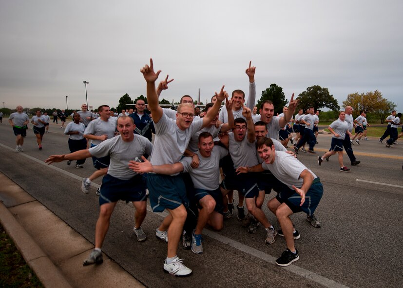 Airmen stop to pose for a picture during a squadron run Sept. 28, 2012, as part of Comprehensive Airmen Fitness Day at Dyess Air Force Base, Texas. The day’s purpose is to strengthen understanding and application of CAF through interactive training and team-building activities. The resiliency training teaches Airmen to respond to stresses in life. There are 12 building blocks to developing resiliency. Each squadron had a resiliency training assistant who focused on teaching three of the 12 resiliency building blocks: assertive communication, hunt the good stuff and avoid thinking traps. (U.S. Air Force photo by Airman 1st Class Damon Kasberg/ Released)