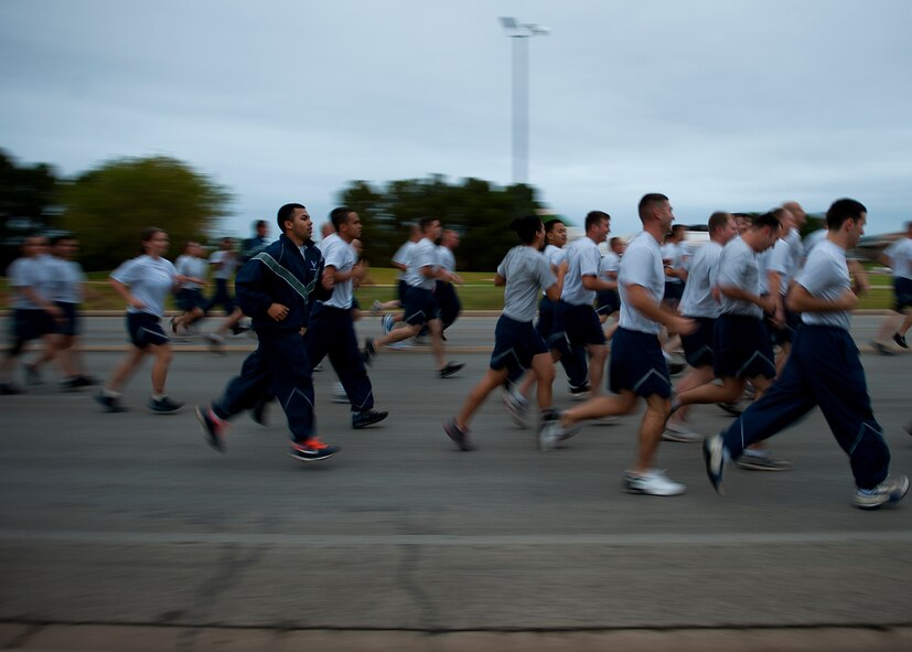 Airmen participate in a squadron run Sept. 28, 2012, as part of Comprehensive Airmen Fitness Day at Dyess Air Force Base, Texas. The day’s purpose is to strengthen understanding and application of CAF through interactive training and team-building activities. The resiliency training teaches Airmen to respond to stresses in life. There are 12 building blocks to developing resiliency. Each squadron had a resiliency training assistant who focused on teaching three of the 12 resiliency building blocks: assertive communication, hunt the good stuff and avoid thinking traps. (U.S. Air Force photo by Airman 1st Class Damon Kasberg/ Released)
