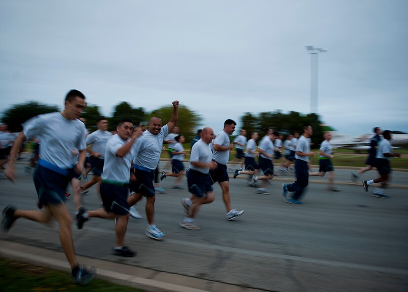 Airmen participate in a squadron run Sept. 28, 2012, as part of Comprehensive Airmen Fitness Day at Dyess Air Force Base, Texas. The day’s purpose is to strengthen understanding and application of CAF through interactive training and team-building activities. The resiliency training teaches Airmen to respond to stresses in life. There are 12 building blocks to developing resiliency. Each squadron had a resiliency training assistant who focused on teaching three of the 12 resiliency building blocks: assertive communication, hunt the good stuff and avoid thinking traps. (U.S. Air Force photo by Airman 1st Class Damon Kasberg/ Released)