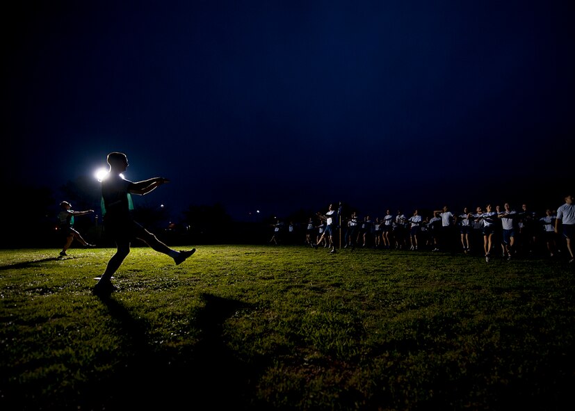 Airmen warm-up prior to a squadron run Sept. 28, 2012, as part of Comprehensive Airmen Fitness Day at Dyess Air Force Base, Texas. The day’s purpose is to strengthen understanding and application of CAF through interactive training and team-building activities. The resiliency training teaches Airmen to respond to stresses in life. There are 12 building blocks to developing resiliency. Each squadron had a resiliency training assistant who focused on teaching three of the 12 resiliency building blocks: assertive communication, hunt the good stuff and avoid thinking traps. (U.S. Air Force photo by Airman 1st Class Damon Kasberg/ Released)