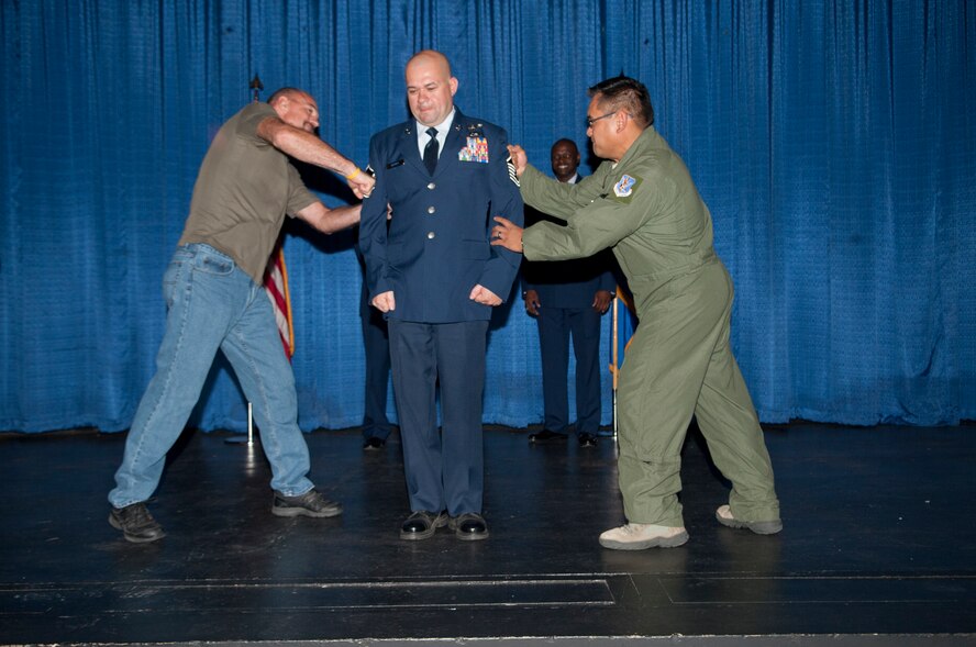 U.S. Air Force Master Sgt. Eric Barker, 347th Operations Support Squadron, receives his new rank during Team Moody’s promotion ceremony at Moody Air Force Base, Ga., Sept. 28, 2012. It is an Air Force tradition for family members or coworkers to tap on the promotion stripes of new promotees. (U.S. Air Force photo by Airman 1st Class Paul Francis/Released)
