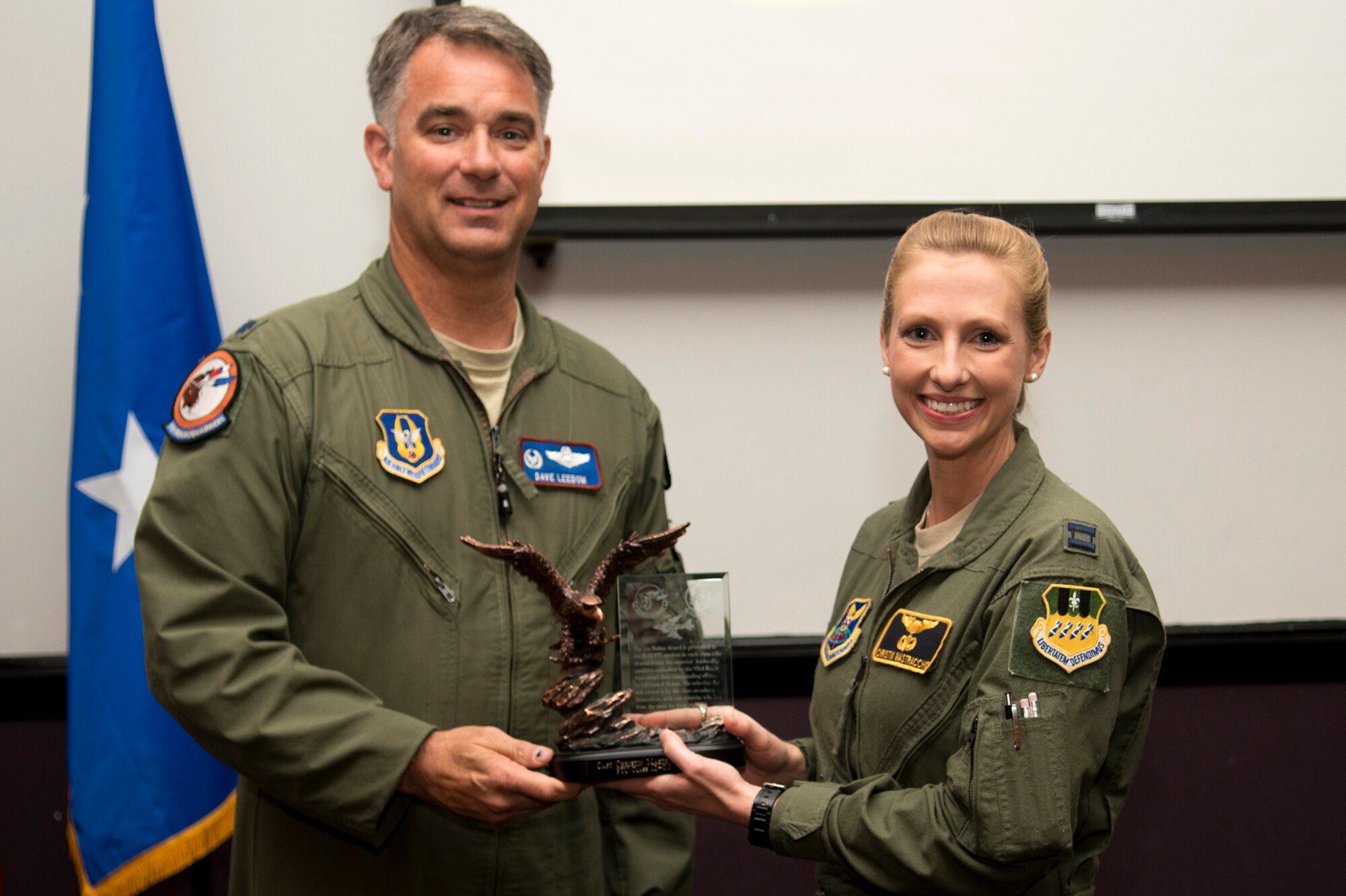 U.S. Air Force Col. David Leedom, 93rd Bomb Squadron commander, presents the Lindell Mabus Leadership Award to Capt. Christin Mastracchio during a B-52 Formal Training Unit Graduation ceremony, Sept. 28, 2012, Barksdale Air Force Base, La. The members of Class 12-02 selected fellow student Mastracchio for the award because of her exceptional leadership that was crucial to the class's graduation. (U.S. Air Force photo by Master Sgt. Greg Steele/Released)