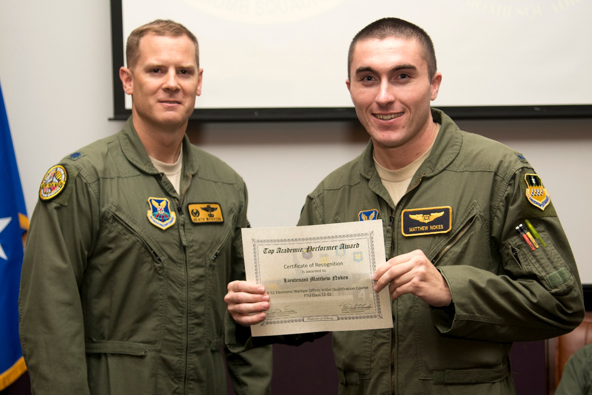 U.S. Air Force 1st Lt. Matthew Nokes receives the Electronic Warfare Officer Outstanding Academic Performer award during a B-52 Formal Training Unit Graduation ceremony, Sept. 28, 2012, Barksdale Air Force Base, La. Nokes achieved an overall average of 99.10 percent. (U.S. Air Force photo by Master Sgt. Greg Steele/Released)