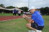 Ian Anderson, a running performance and injury program educator, records video of Joint Base San Antonio-Randolph members as they run the JBSA-Randolph track Sept. 27. Anderson uses the videos  to evaluate running mechanics and recommends compatible footwear. (U.S. Air Force photo by Rich McFadden) 