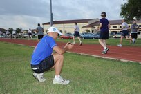 Ian Anderson, a running performance and injury program educator, records video of Joint Base San Antonio-Randolph members as they run the JBSA-Randolph track Sept. 27. Anderson uses the videos to evaluate running mechanics and recommends compatible footwear. (U.S. Air Force photo by Rich McFadden) 