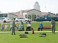 Tech. Sgt. Santiago Bernal and Staff Sgt. Jonathan Royce, 902nd Security Forces Squadron military working dog handlers, demonstrate K-9 detection capabilities to members of The Forum at Lincoln Heights, a local retirement community, during their visit to Joint Base San Antonio-Randolph Sept. 27. (U.S. Air Force photo by Benjamin Faske)