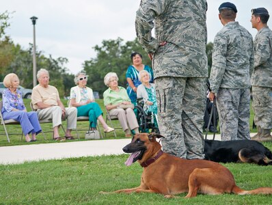 Ccharles and Ttroy, 902nd Security Forces Squadron military working dogs,and their handlers perform a demonstration of capabilities for members of The Forum at Lincoln Heights, a local retirement community, at Joint Base San Antonio-Randolph Sept. 27. (U.S. Air Force photo by Benjamin Faske)