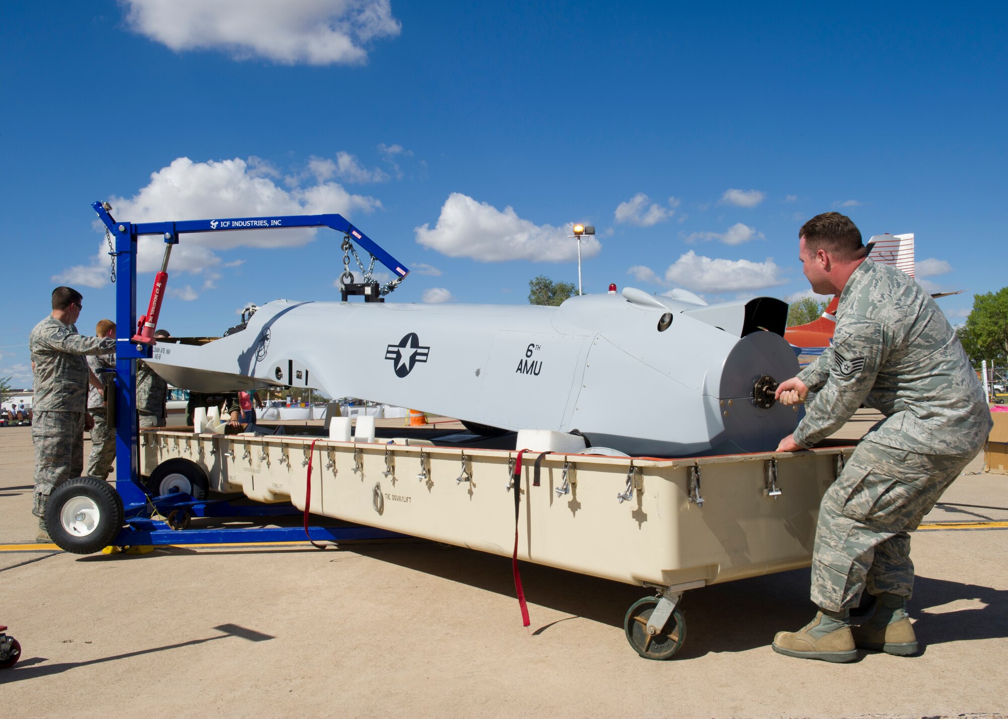Airmen from the 849th Aircraft Maintenance Squadron place the body of a MQ-1B Predator into a casket during the New Mexico Centennial Air Tour in Roswell, N.M., Sept. 29. The Predator is a 1,700 pound, multi-function, surveillance and combat aircraft piloted from ground control stations anywhere in the world. (U.S. Air Force photos by Airman 1st Class Michael Shoemaker/Released)