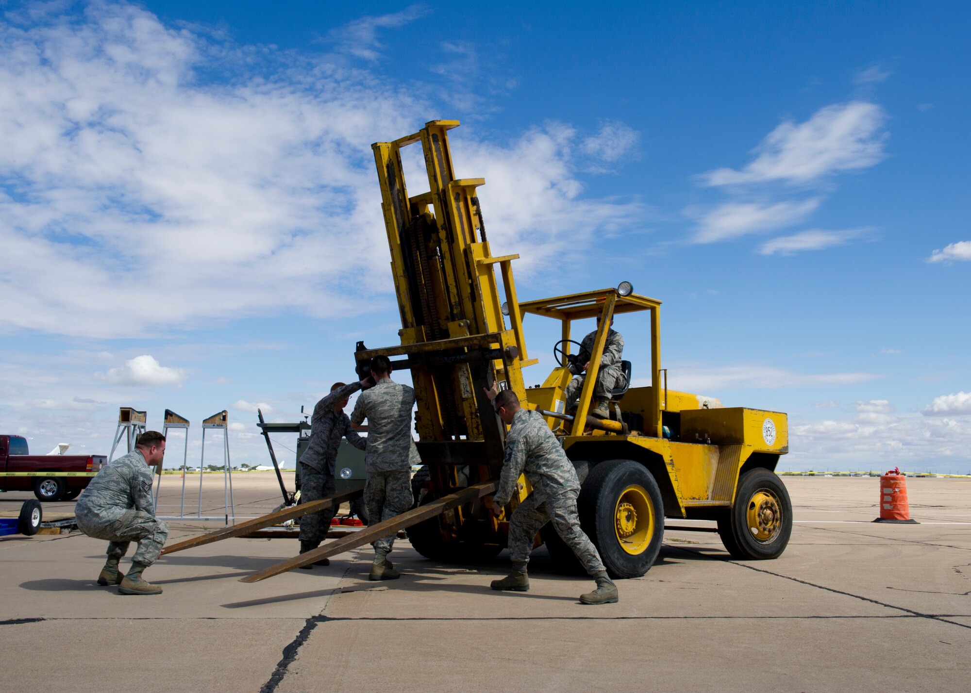 Airmen from the 849th Aircraft Maintenance Squadron prepare a forklift to remove the top of a carrying case, also known as a casket, for a MQ-1B Predator during the New Mexico Centennial Air Tour in Roswell, N.M., Sept. 29. The entire aircraft, which weighs approximately 1,700 pounds, fits into the casket for transport. (U.S. Air Force photo by Airman 1st Class Michael Shoemaker/Released)