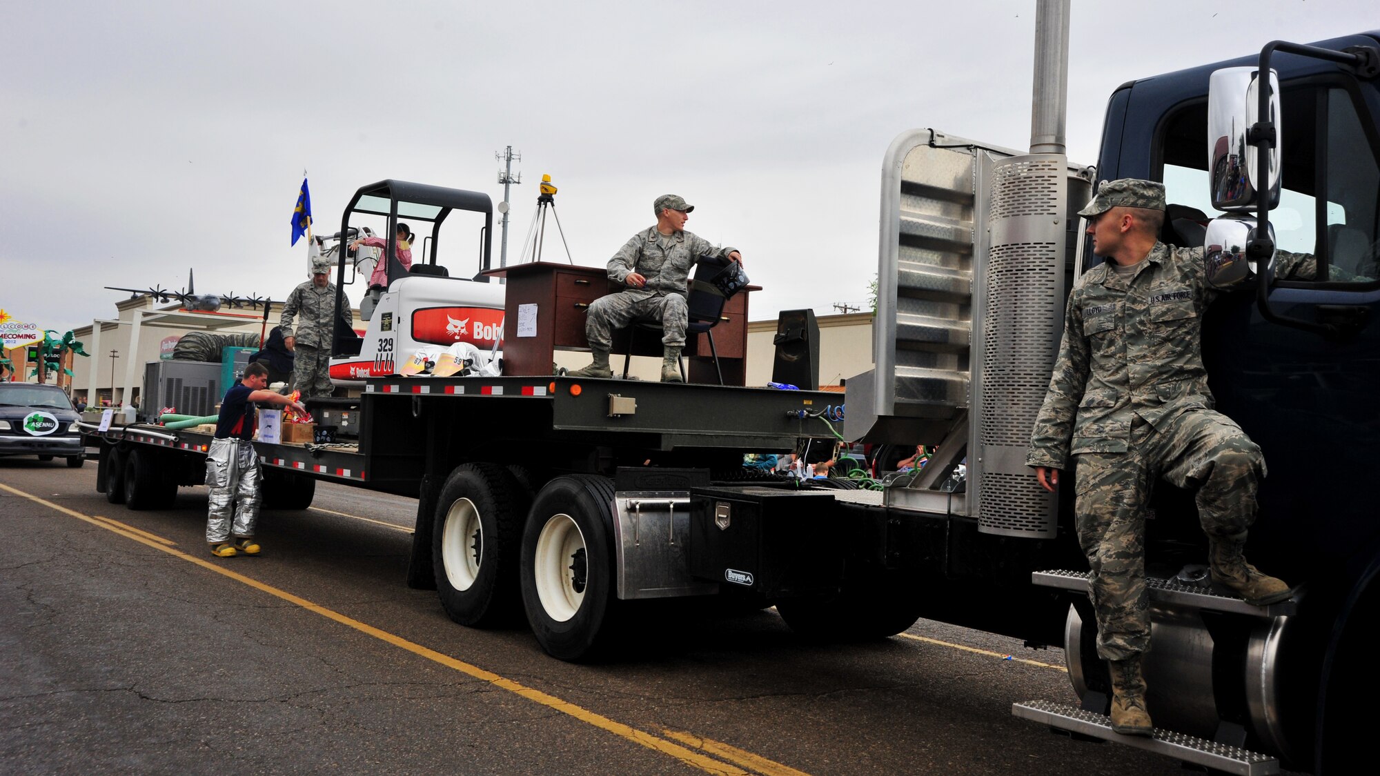 Members of the 27th Special Operations Civil Engineer Squadron ride the float they constructed in honor of Eastern New Mexico University’s homecoming parade in Portales, N.M., Sept. 29, 2012. The float, which was constructed in a matter of days, was designed to visually walk observers through the various stages of planning and construction of ENMU’s Greyhound Stadium. (U.S. Air Force photo/Senior Airman Whitney Tucker)