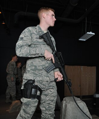 Airman 1st Class Raider Zavodsky a Traditional Reservist with the 477th Security Forces Squadron, trains on the Engagement Skills Trainer 2000 here. The EST 2000 offers a realistic alternative for training in marksmanship, collective and shoot/do not shoot scenarios on both the M-9 and the M-4. The 477th SFS stood up under the 477th FG here March 1.(U.S. Air Force Reserve Photo/Tech. Sgt. Dana Rosso) 