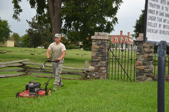 Airman 1st Class Jamesrey De Dios, an airman in services training from the 345th Training Squadron military training flight, mows the lawn at City Point in Hopewell to help landscape the area. Airmen from the MTF volunteer their time while awaiting class start dates at several locations through their partnership with the Petersburg National Battlefield. The Airmen have contributed more than 7,200 hours and saved the battlefield at least $108,000 since they started in March. (U.S. Army photo/Amy Perry)

