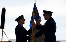 U.S. Air Force Col. Jim Slife, commander of 1st Special Operations Wing, left, receives the guidon from Lt. Col. Thomas Geiser, commander of 6th Special Operations Squadron, right, during the 6th SOS transition ceremony at the Commando Hangar on Hurlburt Field, Fla., Sept. 27, 2012. The 6th SOS is relocating to Duke Field, Fla., and transferring command to the Air Force Special Operations Training Center. (U.S. Air Force Photo/Airman 1st Class Naomi M. Griego)