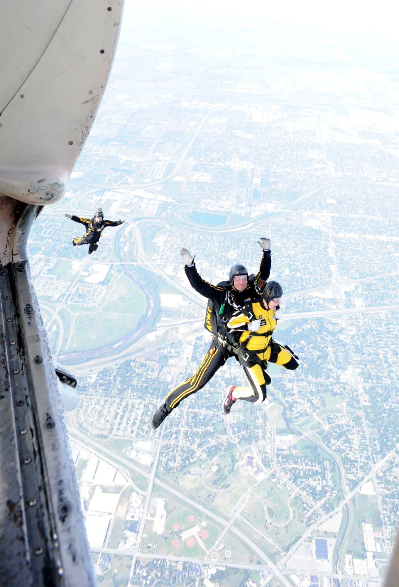 Amanda Chastain, 22nd Civil Engineer Squadron spouse, and U.S. Army Sergeant First Class Aaron Figel, U.S. Army Parachute Team assistant tandem team leader, prepare to exit the C-31A Friendship Fokker Sept. 29, 2012, over McConnell Air Force Base, Kan. Chastain was granted the opportunity to tandem jump in recognition for being named the 2012 Joan Orr Air Force Spouse of the Year. (U.S. Air Force photo/Senior Airman Laura L. Valentine)