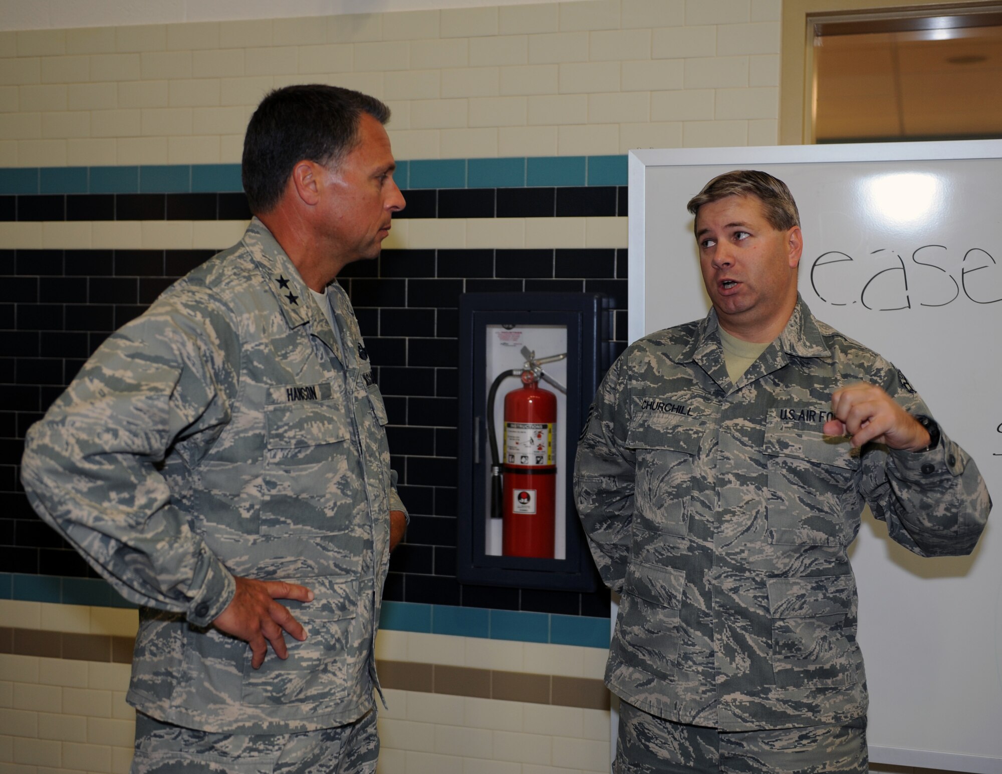 Maj. Gen. Scott Hanson recalls the wing’s history as he tours the wing headquarters building with the 92nd Air Refueling Wing commander, Col. Brian Newberry, Sept. 25, 2012. Hanson, the wing commander at Fairchild Air Force Base, Wash., from 2005 to 2007, returned here to speak at the base's 2012 Air Force Ball. He is currently the Air War College commandant at Maxwell Air Force Base, Ala. (U.S. Air Force photo by Staff Sgt. J.G. Buzanowski)