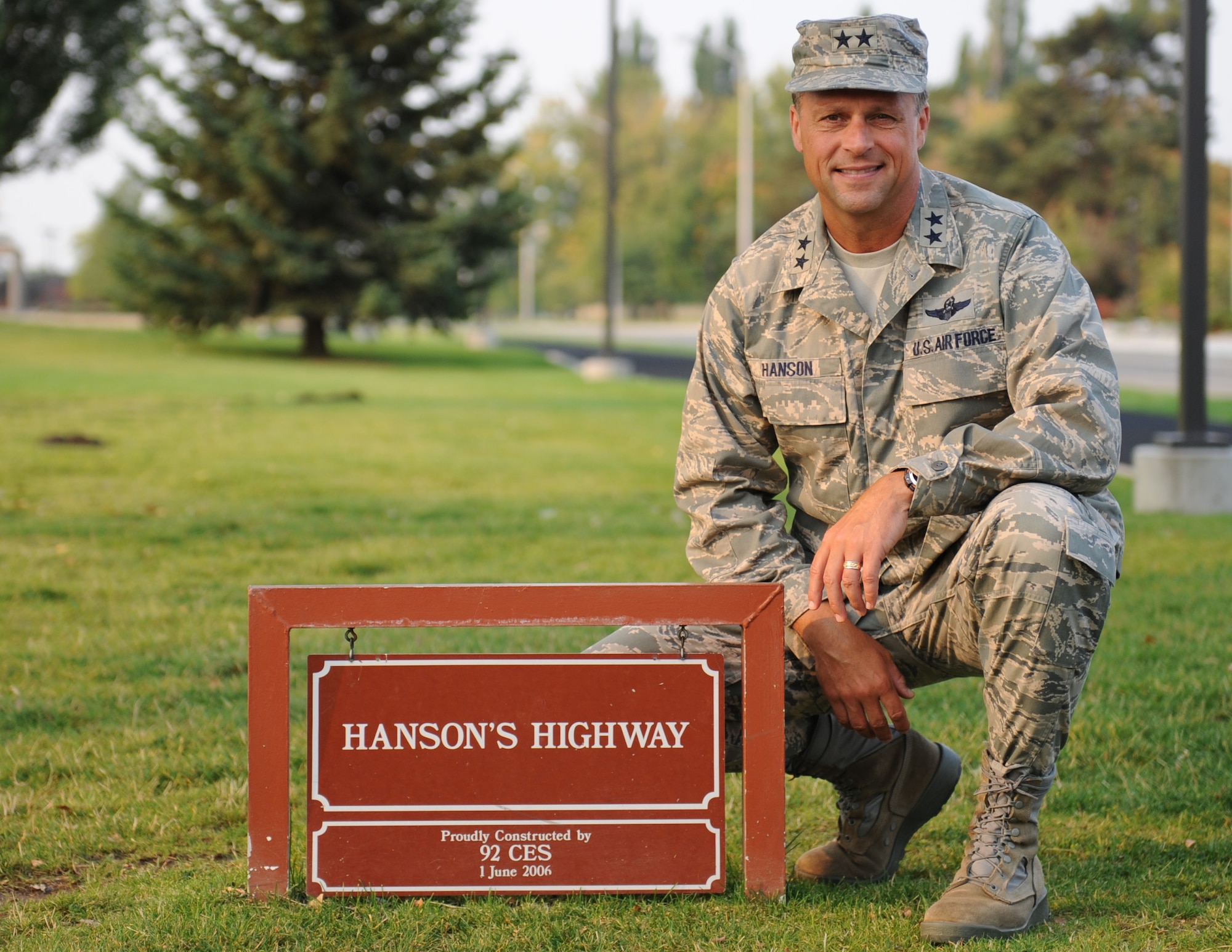 Maj. Gen. Scott Hanson poses near the sign commemorating Hanson's Highway, an outdoor running track near the fitness center, during his visit to Fairchild Air Force Base, Wash., Sept. 25, 2012. Hanson was the 92nd Air Refueling Wing commander from 2005 to 2007 and returned to Fairchild to speak at the base's 2012 Air Force Ball. During his visit, the general was treated to a tour of the base by the current wing commander, Col. Brian Newberry. Hanson currently serves as the Air War College commandant at Maxwell Air Force Base, Ala. (U.S. Air Force photo by Staff Sgt. J.G. Buzanowski)