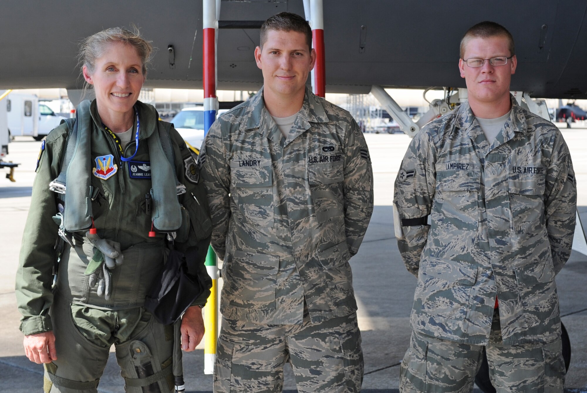 U.S. Air Force Col. Jeannie Leavitt, 4th Fighter Wing commander, poses for a photo with Senior Airman Joey Landry and Airman 1st Class Thomas Lampirez, 4th Aircraft Maintenance Squadron crew chiefs, after flying the final sortie of fiscal year 12 on Seymour Johnson Air Force Base, Sept. 26, 2012. The four fighter squadrons from the 4th FW flew approximately 72 sorties a day to meet Air Combat Command flying hour requirements. (U.S. Air Force photo/Senior Airman Gino Reyes/Released)