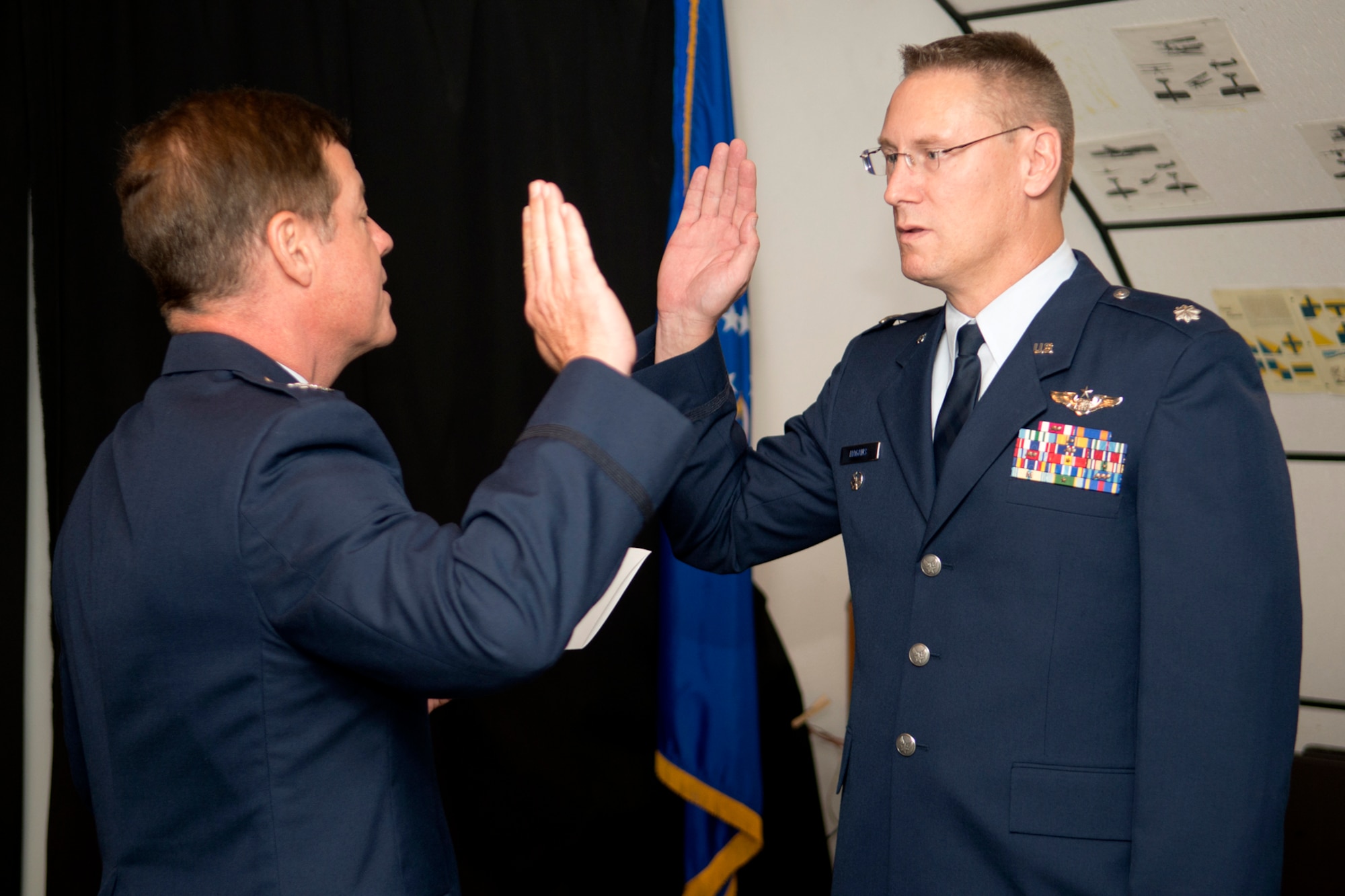 U.S. Air Force Lt. Col. Joseph Hagans (right) recites the oath from Col. Keith Schultz, 307th Bomb Wing commander, during a Pinning On ceremony, Sept. 28, 2012, Barksdale Air Force Base, La. Hagan was is a reservist assigned to the 343rd Bomb Squadron at Barksdale. (U.S. Air Force photo by Master Sgt. Greg Steele/Released)