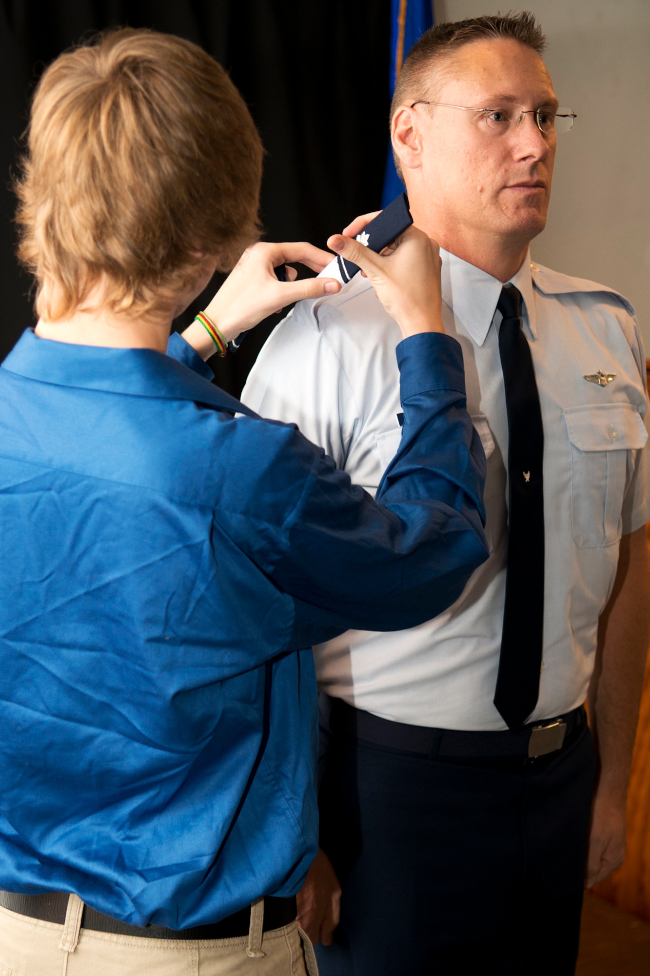Andrew Hagans puts an epaulette on his dad, Lt. Col. Joseph Hagans, during a Pinning On ceremony, Sept. 28, 2012, Barksdale Air Force Base, La. Hagans was recently promoted to the rank of Lt. Col. and is assigned to the 343rd Bomb Squadron at Barksdale. (U.S. Air Force photo by Master Sgt. Greg Steele/Released)