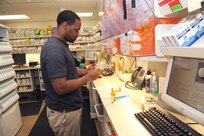 Keeli Lott, 359th Aerospace Medicine Support Squadron pharmacy technician., fills prescriptions for Joint Base San Antonio-Randolph members using the new expanded formulary at the Randolph clinic Sept. 27. (U.S. Air Force photo by Rich McFadden) 