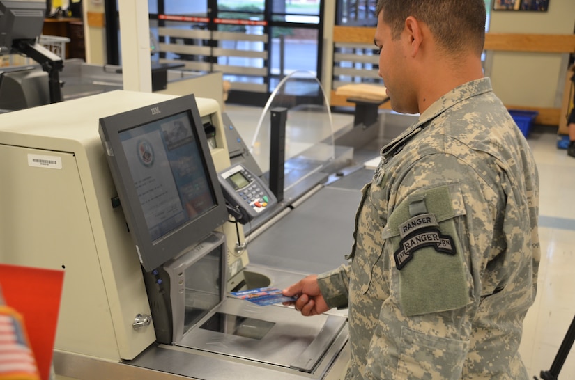 A Soldier scans his Commissary Rewards Card at a self-checkout register at the Fort Lee, Va., Commissary. The new rewards card, now available at Joint Base Langley-Eustis' commissaries, allows customers to access digital coupons online and redeem them in any commissary by scanning the card at checkout. (Courtesy photo by Kevin L. Robinson / Released)