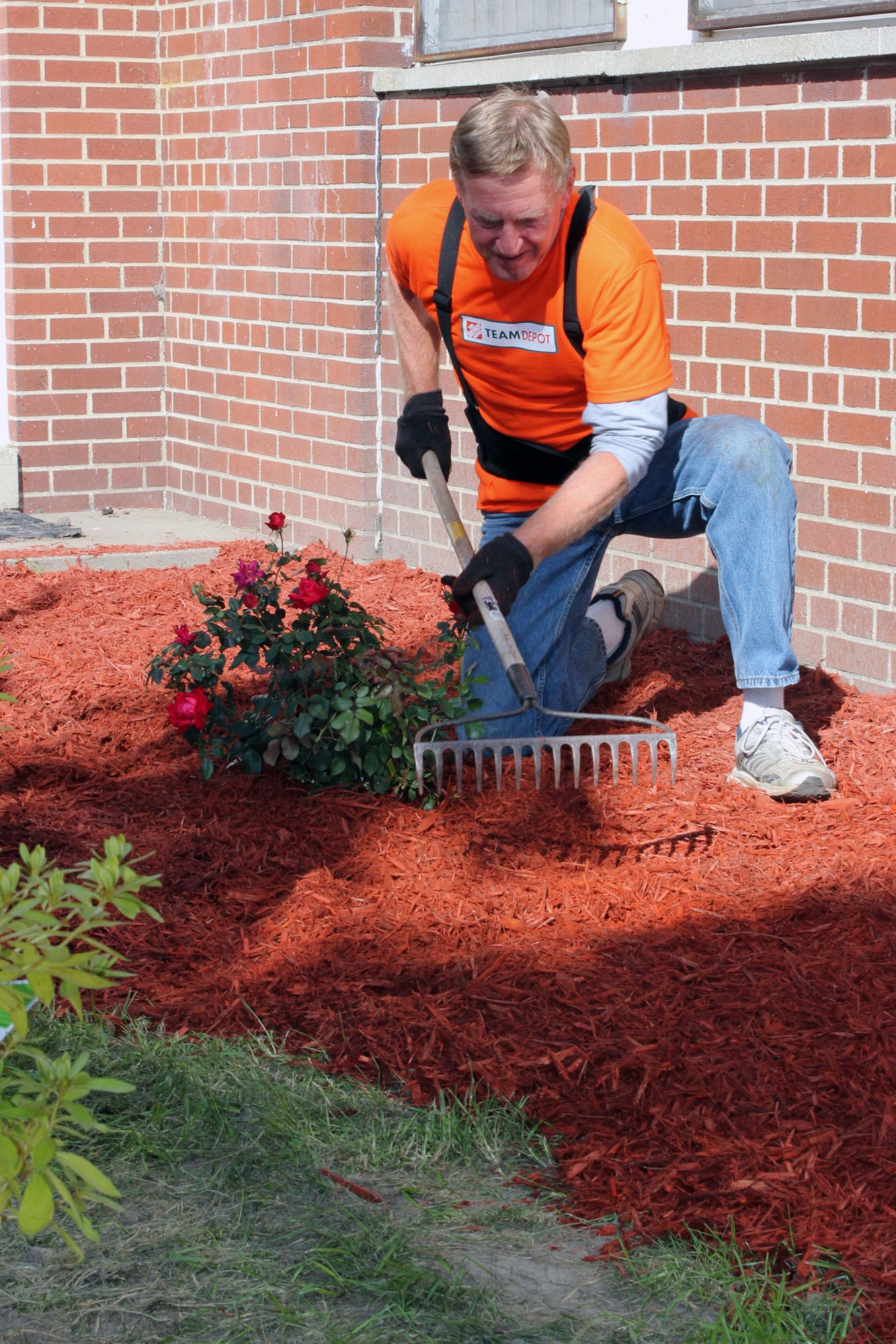 Mike Kauzlarich, a Home Depot employee and a member of that company’s volunteer team, rakes a flower garden near a gazebo outside of the base chapel at Selfridge Air National Guard Base, Mich., Sept. 27, 2012. Volunteers from Home Depot helped to beautify the gazebo area as part of a campaign to honor area military personnel. (Air National Guard photo by TSgt. Dan Heaton)