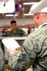 Master Sgt. Richard McCorkle, 319th Operations Support Squadron first sergeant, prepares another plate of food for a junior enlisted member during the Airmen Appreciation Dinner, Sept. 26, 2012, on Grand Forks Air Force Base, N.D. Dinners such as this are held during different times of the year by the 319th Air Base Wing senior leadership as a way to thank the Airmen for all they do to get the mission done. (U.S. Air Force photo /Staff Sgt. Amanda N. Grabiec)