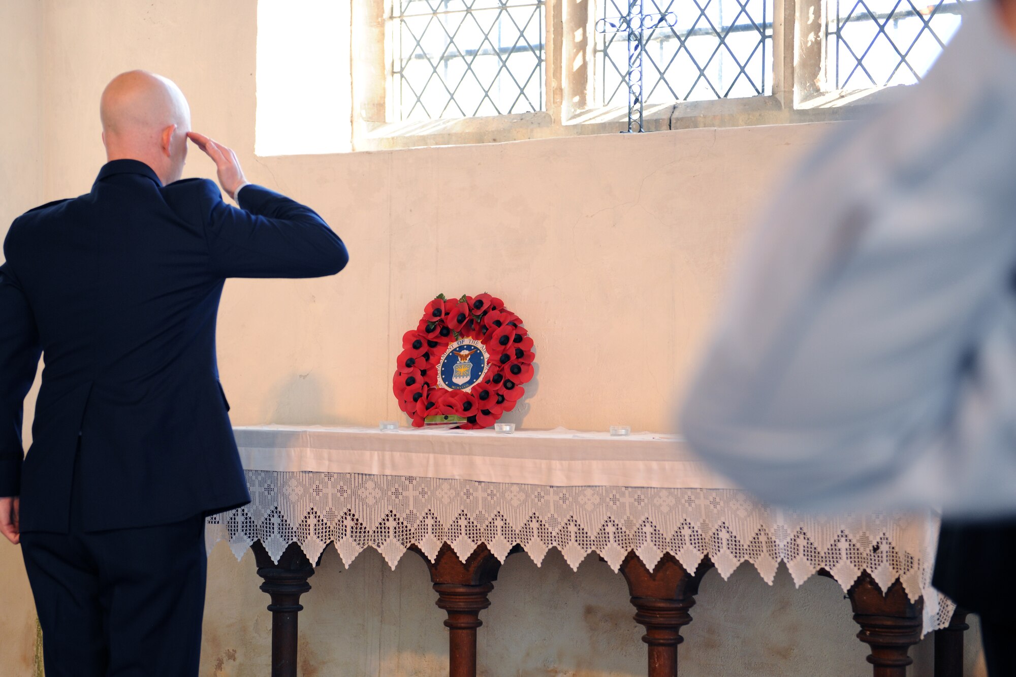 EAST HORNDON, England- Capt. John Williams, 351st Air Refueling Squadron, salutes following a wreath laying at a commemoration service Sept. 29, 2012, at the Church of All Saints. This service was to commemorate the 69th anniversary of the Sept. 26, 1943, air disaster involving the Dorsal Queen and Raunchy Wolf.  The two B-17 Flying Fortresses collided killing 21 Americans who were returning to England following a bombing mission during World War II. Airmen assigned to RAF Mildenhall were invited to the ceremony to present a wreath in honor of the deceased. (U.S. Air Force photo/Master Sgt. Brian M. Boisvert)