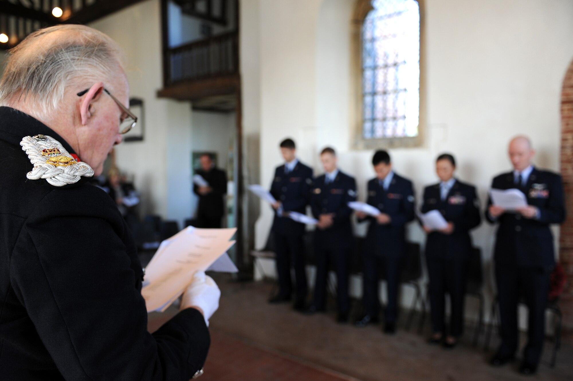 EAST HORNDON, England-- Lord Petre, Lord Lieutenant of Essex sings opening hymns during a remembrance service Sept. 29, 2012, at the Church of All Saints. This service was to commemorate the 69th anniversary of the Sept. 26, 1943, air disaster involving the Dorsal Queen and Raunchy Wolf.  The two B-17 Flying Fortresses collided killing 21 Americans who were returning to England following a bombing mission during World War II. Airmen assigned to RAF Mildenhall were invited to the ceremony to present a wreath in honor of the deceased. (U.S. Air Force photo/Master Sgt. Brian M. Boisvert)