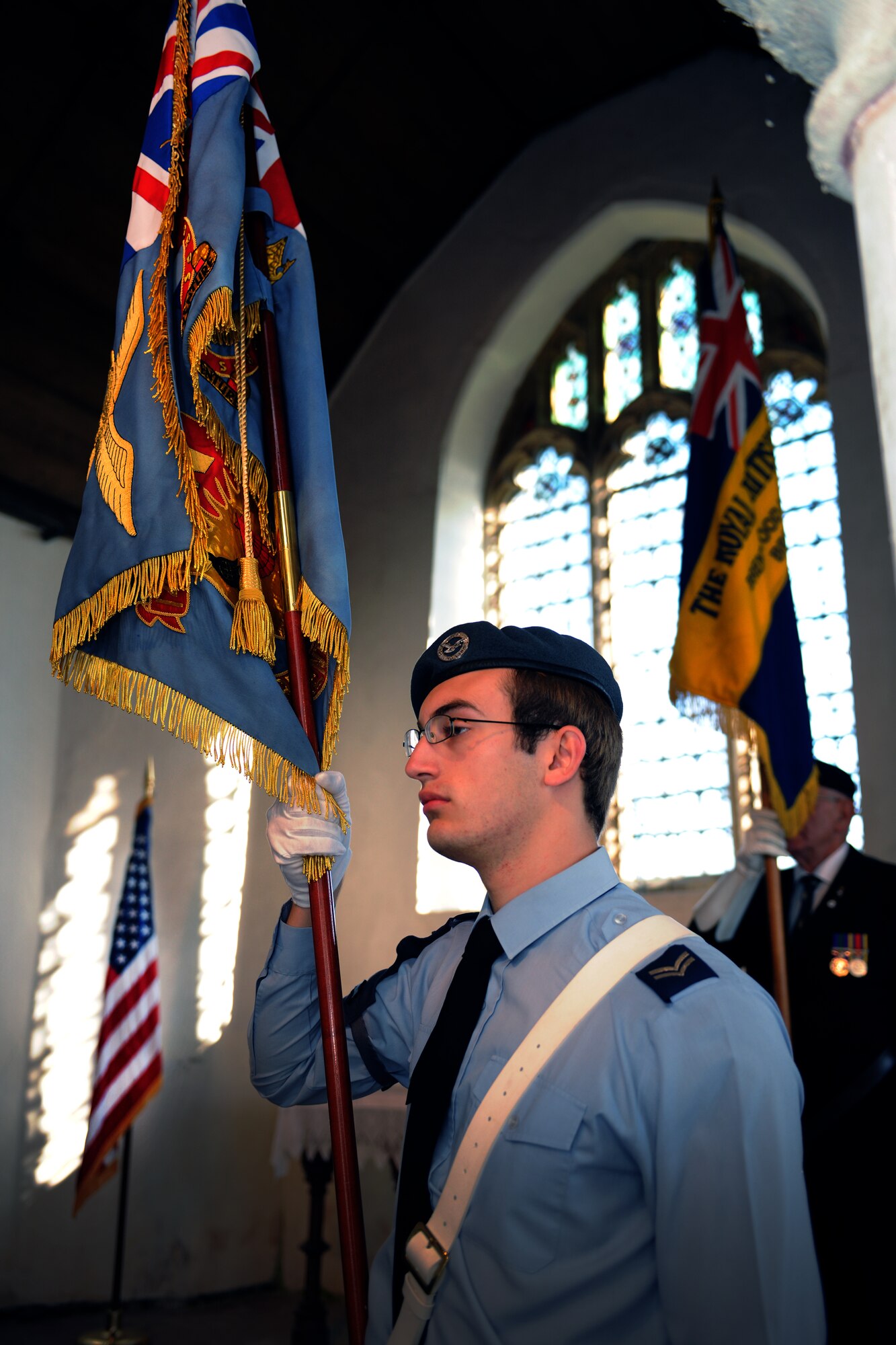 EAST HORNDON, England--A flag bearer from the Air Training Corps stands at attention during a remembrance service Sept. 29, 2012, at the Church of All Saints. This service was to commemorate the 69th anniversary of the Sept. 26, 1943, air disaster involving the Dorsal Queen and Raunchy Wolf.   The two B-17 Flying Fortresses collided killing 21 Americans who were returning to England following a bombing mission during World War II. (U.S. Air Force photo/Master Sgt. Brian M. Boisvert)