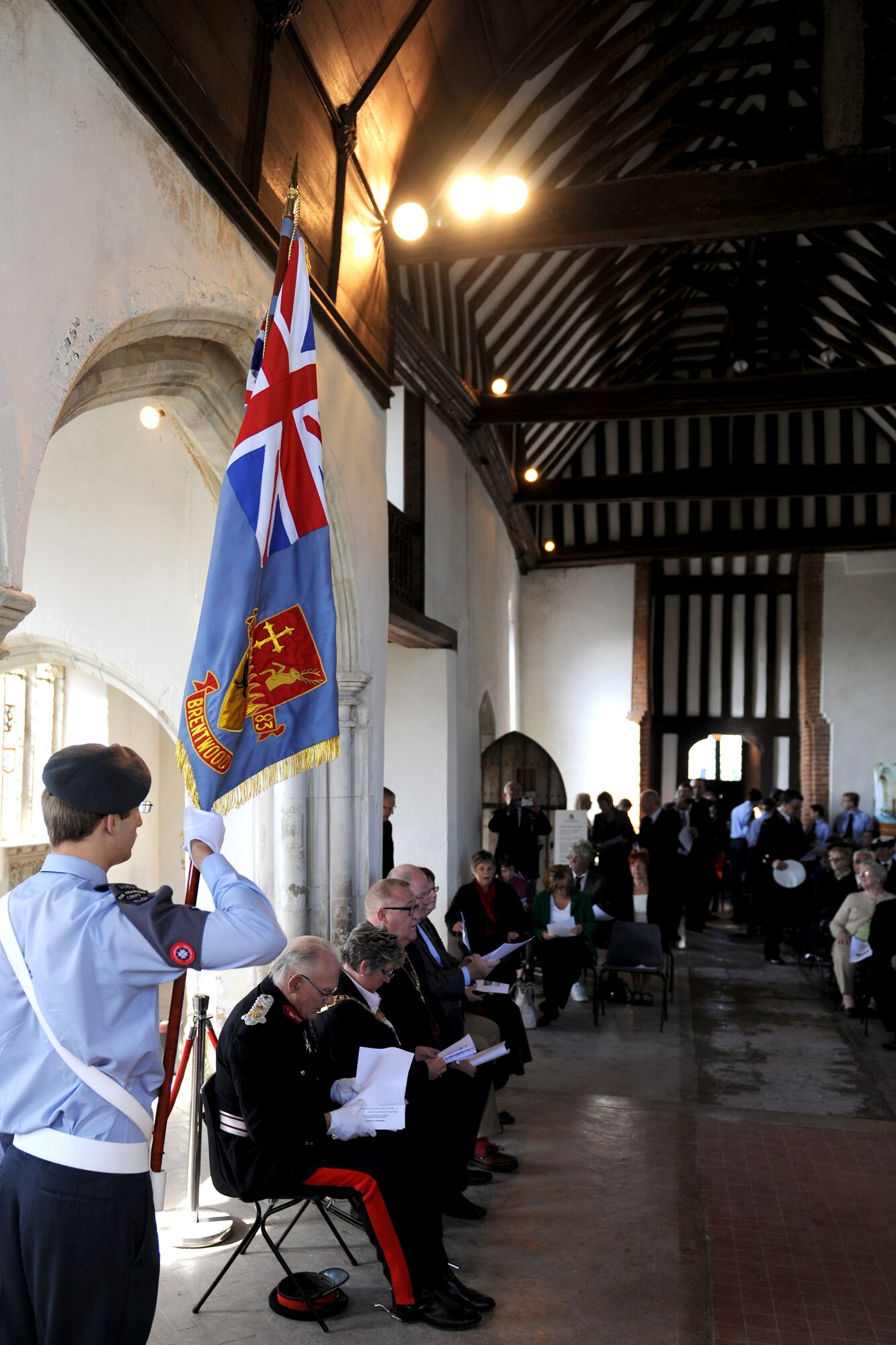 EAST HORNDON, England--A flag bearer from the Air Training Corps stands at attention prior to a remembrance service Sept. 29, 2012, at the Church of All Saints.  This service was to commemorate the 69th anniversary of the Sept. 26, 1943, air disaster involving the Dorsal Queen and Raunchy Wolf.  The two B-17 Flying Fortresses collided killing 21 Americans who were returning to England following a bombing mission during World War II. (U.S. Air Force photo/Master Sgt. Brian M. Boisvert)