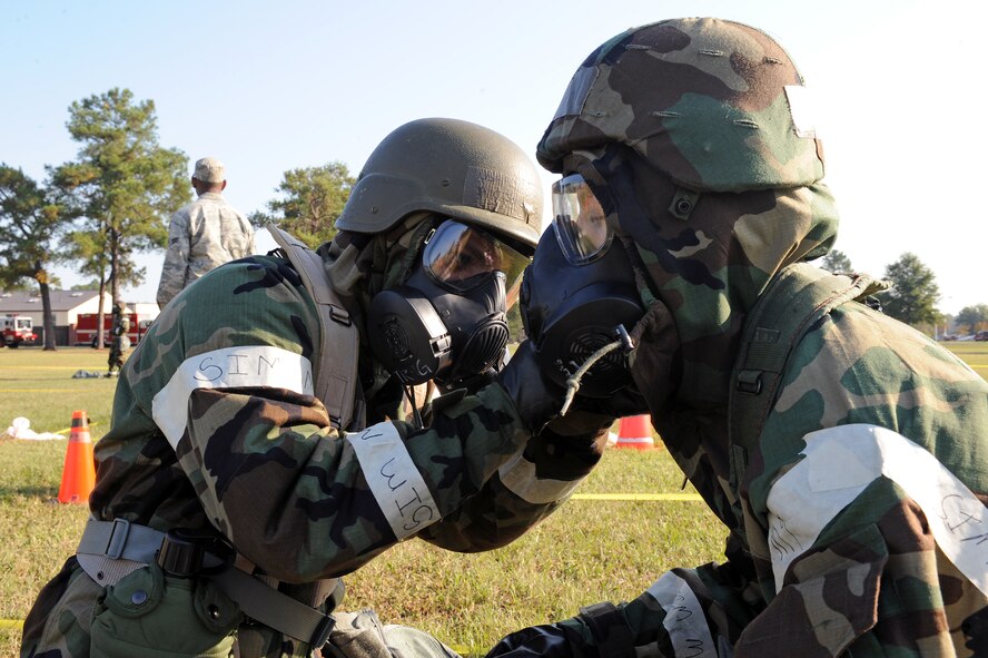 U.S. Air Force Airman 1st Class Jeremy Brothers, 4th Communications Squadron client support center operator, performs a buddy check on Airman 1st Class Garrett Johnson, 4th CS communications focal point operator, during an ability to survive and operate exercise on Seymour Johnson Air Force Base, N.C., Sept. 26, 2012. Buddy checks ensure that all mission oriented protective posture gear is properly worn and mission ready. (U.S. Air Force photo/Airman 1st Class John Nieves Camacho/Released)