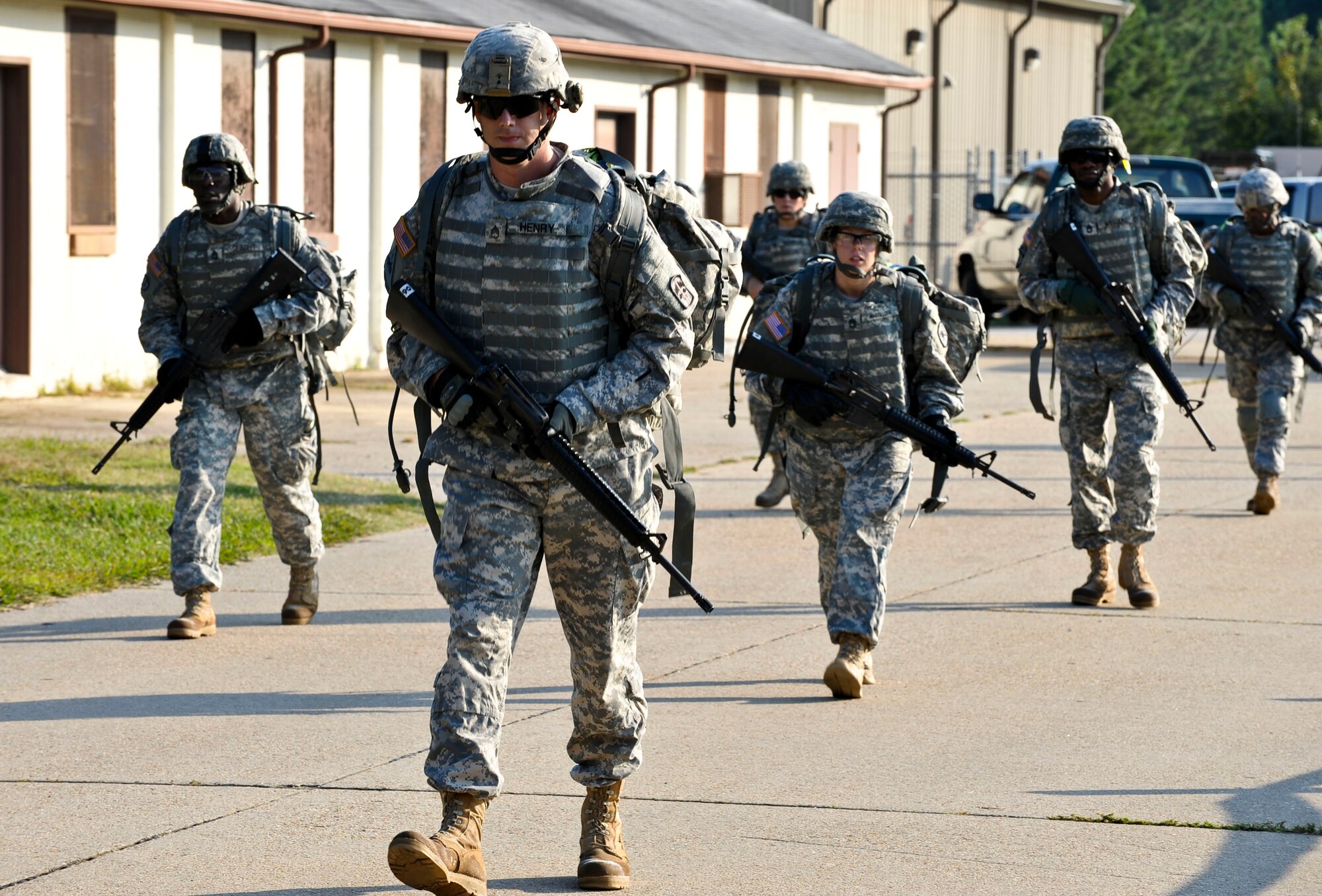 Soldiers hike to the firing range following weapons calibration during the 2012 Advanced Individual Training Platoon Sergeant of the Year competition at Fort Eustis, Va., Sept. 26, 2012. Weapons qualification was one of several tests Soldiers faced during the week-long competition, which was hosted by the U.S. Army Training and Doctrine Command. (U.S. Air Force photo by Staff Sgt. Wesley Farnsworth/Released)