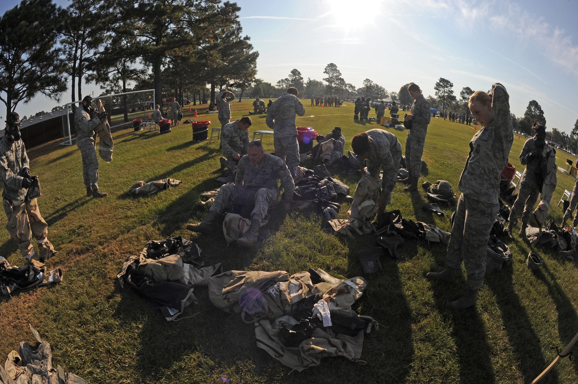 U.S. Air Force Airmen assigned to the 4th Fighter Wing take off mission oriented protective posture gear after completion of an ability to survive and operate exercise on Seymour Johnson Air Force Base, N.C., Sept. 26, 2012. Airmen participate in multiple stations to prepare them for future operational readiness exercises and operational readiness inspections. (U.S. Air Force photo/Airman 1st Class John Nieves Camacho/Released)