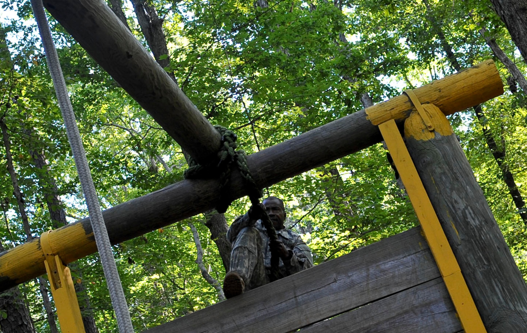 U.S. Army Sgt. 1st Class Delroy Barnett, a Soldier assigned to the 32nd Medical Brigade at Fort Sam Houstin, Texas, navigates through the obstacle course during the annual Platoon Sergeant of the Year competition at Fort Eustis, Va., Sept. 25, 2012. The competition, hosted by the U.S. Army Training and Doctrine Command, tested competitors' abilities both physically and mentally. (U.S. Air Force photo by Staff Sgt. Wesley Farnsworth/Released) 