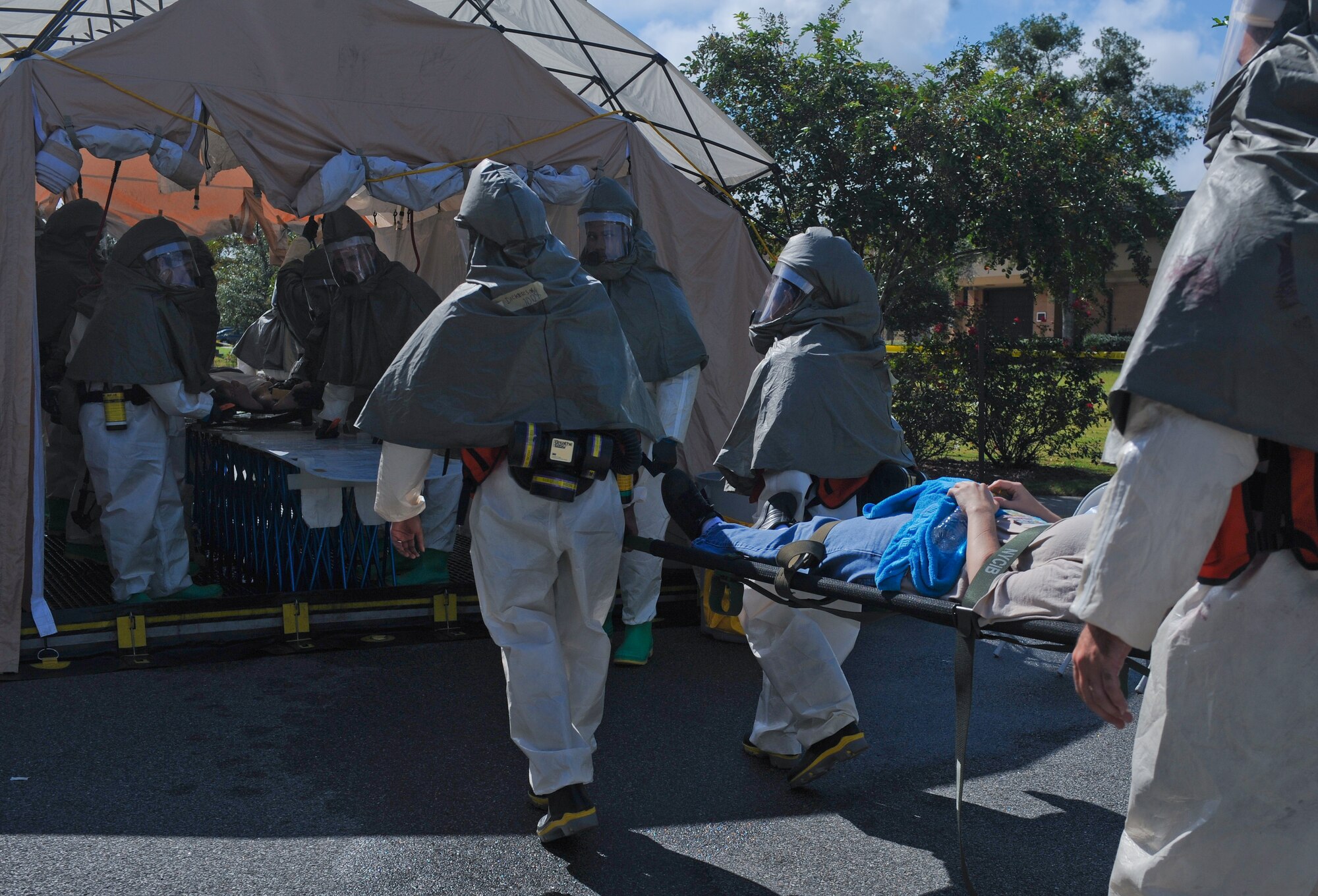 Airmen from the 23d Medical Group carry a moulage victim to the decontamination tent after a simulated plane crash at Moody Air Force Base, Ga., Sept. 27, 2012.  The exercise prepared Team Moody to respond quickly to a real-world situation during the upcoming open house. (U.S. Air Force photo by Airman 1st Class Olivia Dominique/Released)