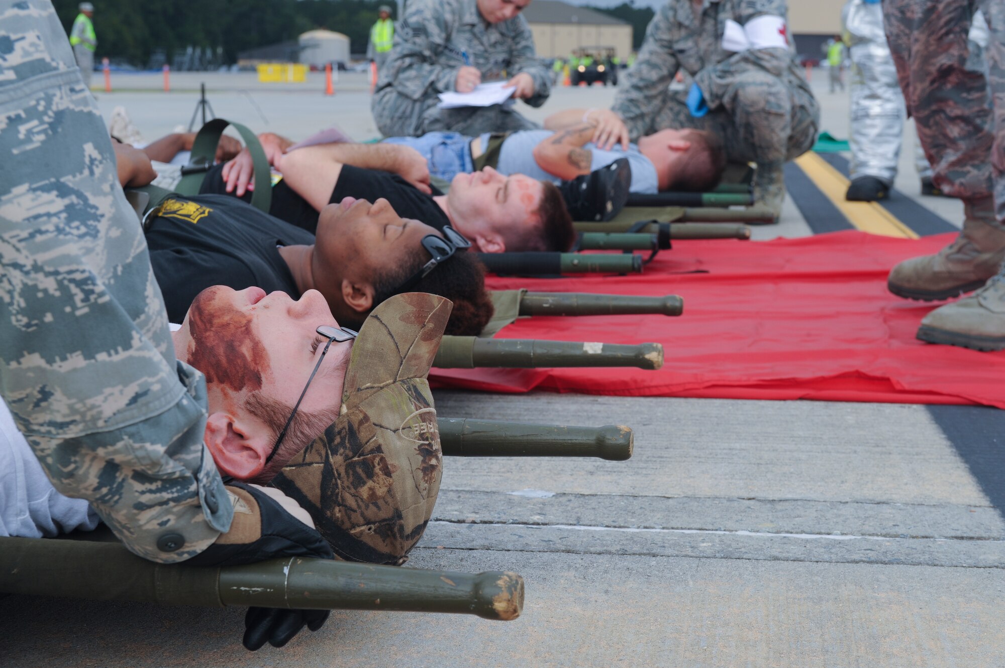 Moulage victims lay on litters after a simulated plane crash at Moody Air Force Base, Ga., Sept. 27, 2012. Team Moody participated in a major accident response exercise to ensure readiness in the event of an accident for the upcoming open house. (U.S. Air Force photo by Airman 1st Class Olivia Dominique/Released)