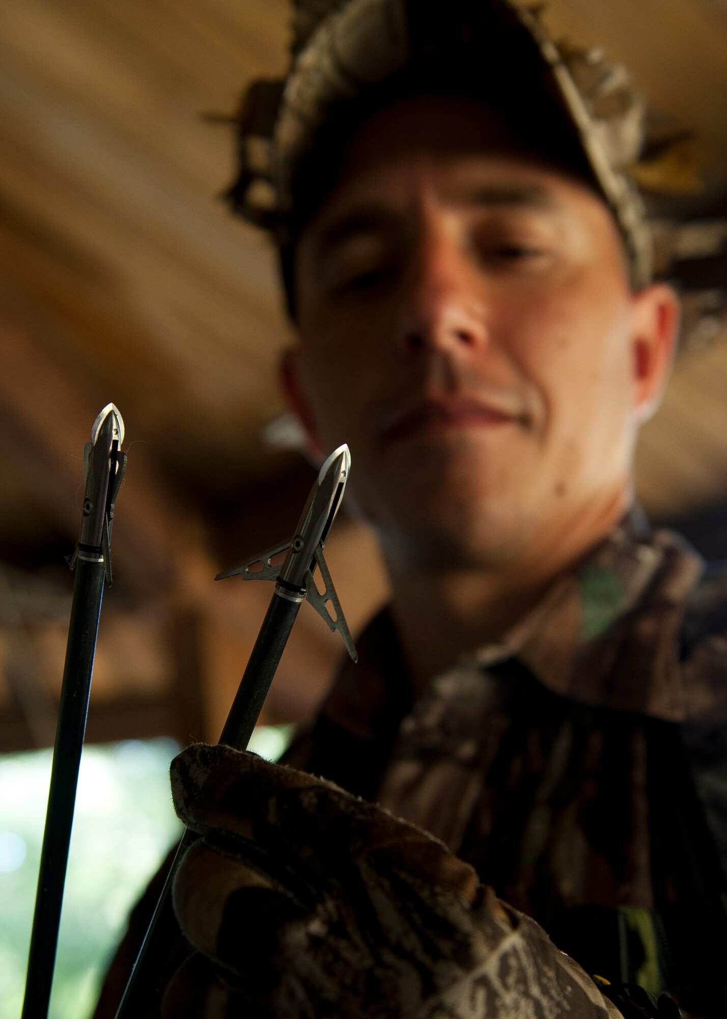 Maj. Samuel Gaglio, Air Combat Command, Electronic Warfare Operations Branch chief, inspects two of his arrows after a practice at the designated hunting area on Langley Air Force Base, Va., Sept. 22, 2012. The Langley hunting program is open to active-duty, Guard, Reserve, Department of Defense civilians, retirees and dependents. (U.S. Air Force Photo by Staff Sgt. John D. Strong II/Released)