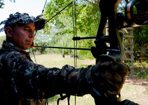 Maj. Samuel Gaglio, Air Combat Command, Electronic Warfare Operations Branch chief, draws his bow toward practice targets at a designated hunting area on Langley Air Force Base, Va., Sept. 22, 2012. The Langley hunting program, in conjunction with the U.S. Department of Agriculture, helps keep the deer population on base under control. (U.S. Air Force Photo by Staff Sgt. John D. Strong II/Released)