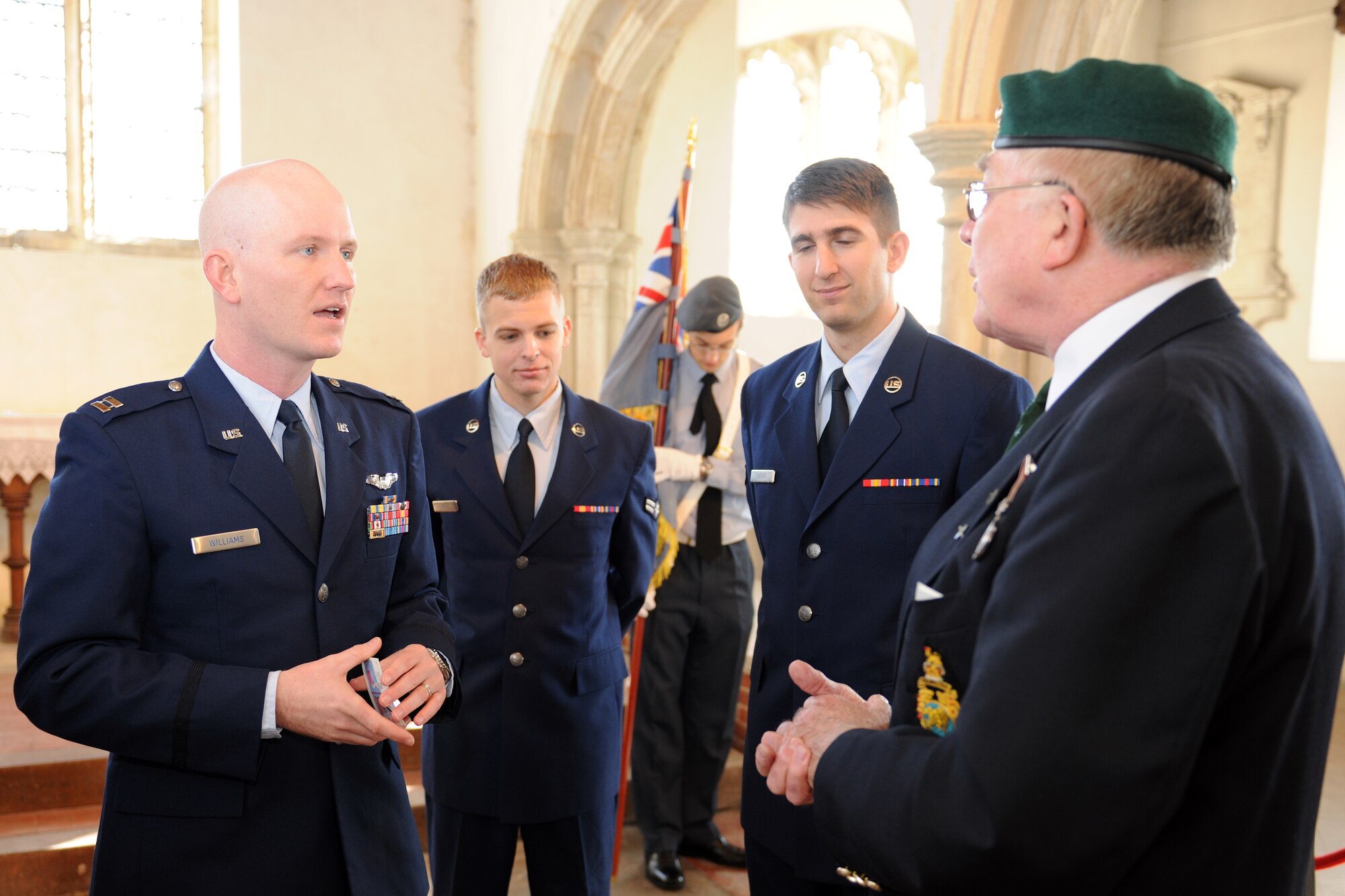EAST HORNDON, England--Capt. John Williams, 351st Air Refueling Squadron, speaks with Mike Hughes,former Royal Marines Commando,  prior to a remembrance service Sept. 29, 2012, at the Church of All Saints.  This service was to commemorate the 69th anniversary of the Sept. 26, 1943, air disaster involving the Dorsal Queen and Raunchy Wolf.  The two B-17 Flying Fortresses collided killing 21 Americans who were returning to England following a bombing mission during World War II. (U.S. Air Force photo/Master Sgt. Brian M. Boisvert)
