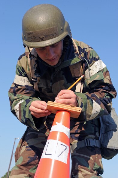 U.S. Air Force Airman 1st Class Jeremy Brothers, 4th Communications Squadron client support center operator, writes the time and date on a piece of M-8 paper during an ability to survive and operate exercise on Seymour Johnson Air Force Base, N.C., Sept. 26, 2012. Airmen use M-8 paper to detect chemical agents in the immediate area by looking for patterns and colors corresponding to chemical agents. (U.S. Air Force photo/Airman 1st Class John Nieves Camacho/Released)