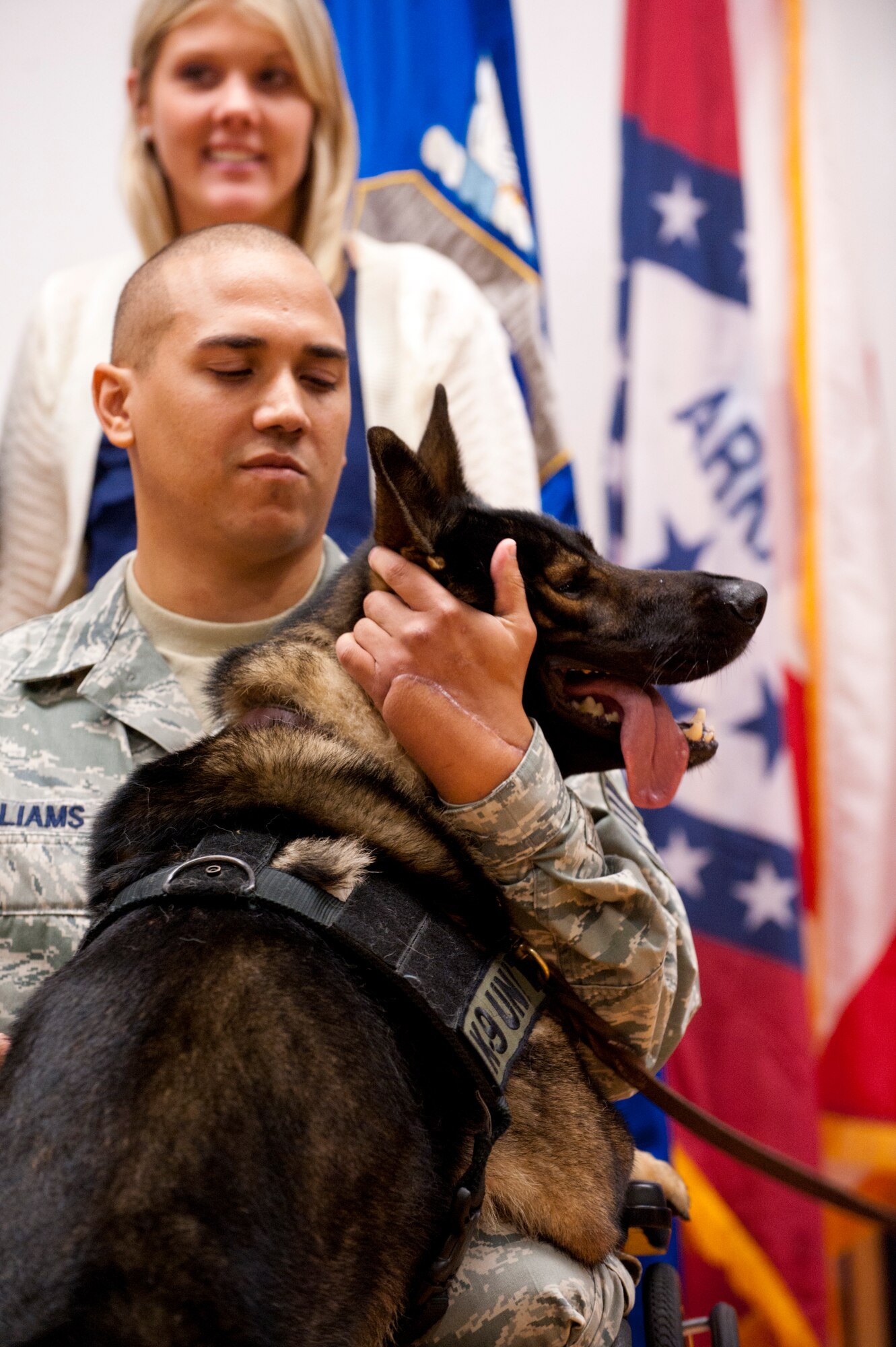 Staff Sgt. Brian Williams, a 87th Security Forces Squadron military working dog handler, greets his military working dog Carly after his awards ceremony in the Joint Base Theatre here Sept. 28. Williams received the Purple Heart, Air Force Combat Action Medal and Bronze Star Medal from Gen. Raymond E. Johns, Air Mobility Command commander, during the event.

(Official U.S. Air Force photo Russ Meseroll/released)
