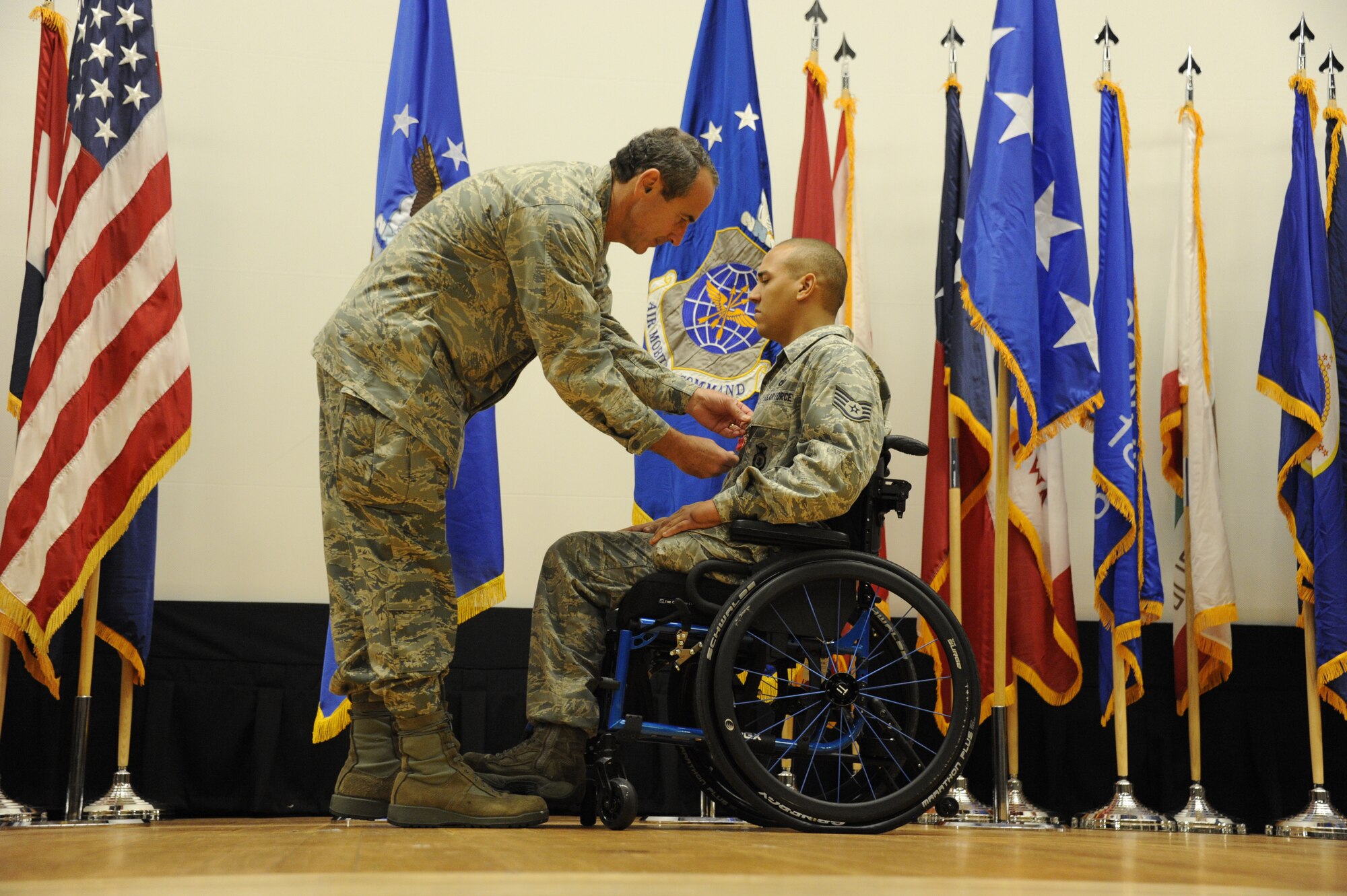 Staff Sgt. Brian Williams, a 87th Security Forces Squadron military working dog handler, receives the Bronze Star Medal from Gen. Raymond E. Johns, Air Mobility Command commander, at a ceremony held in the Joint Base Theatre here Sept. 28. Williams also received the Purple Heart and Air Force Combat Action Medal as well.

(Official U.S. Air Force photo 2nd Lt. David J. Murphy/released)
