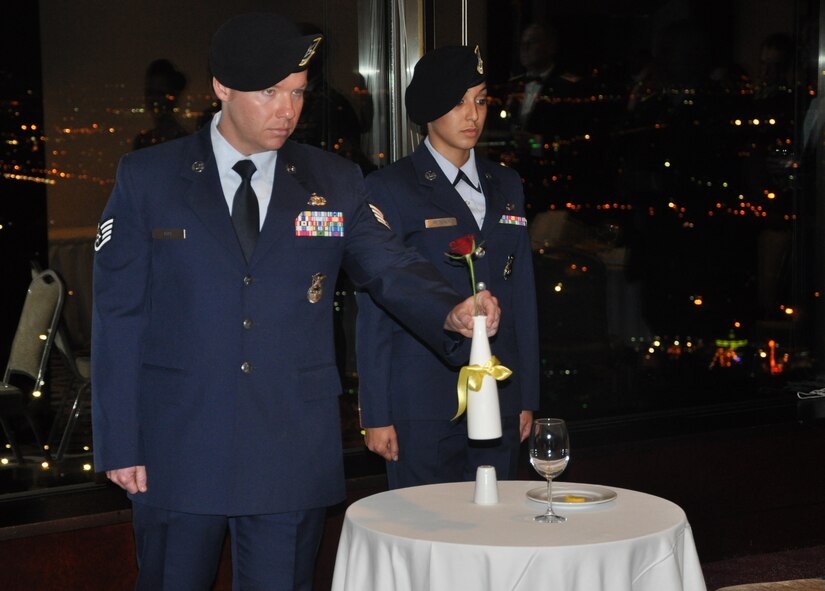 Staff Sgt. Tanner Ray (left) and Senior Airman Anjioulet Petsalis, 425th Air Base Squadron Security Forces Flight, display a single red rose during the Prisoner-of-War/ Missing-in-Action ceremony at the Izmir Air Force Ball Sept. 21, 2012, at Izmir Air Station, Turkey. (Photo by Tanju Varlikli)
