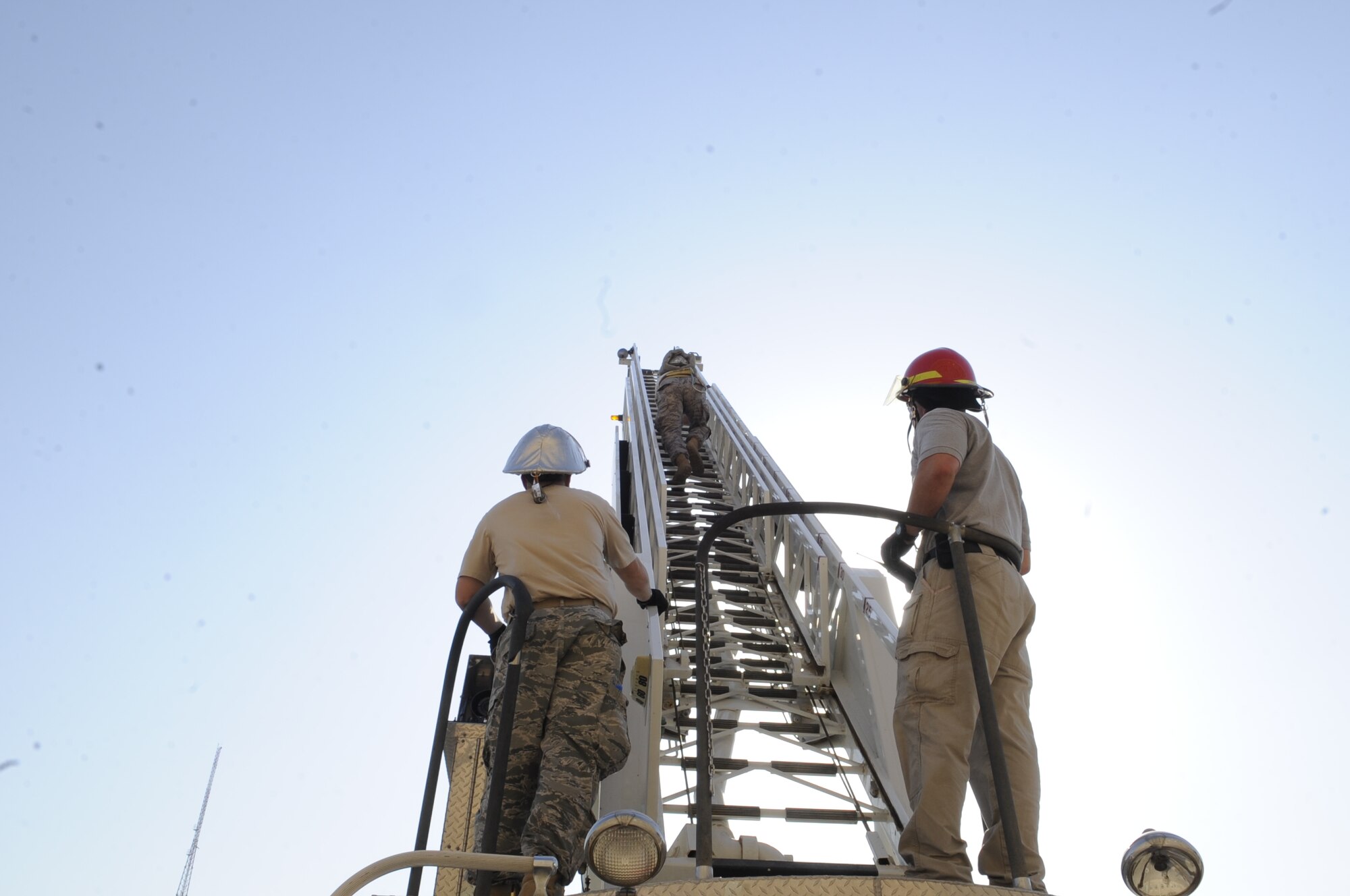 SOUTHWEST ASIA – A member of the 386th Expeditionary Civil Engineer Squadron, fire department, climbs the 77-foot ladder during the practical portion of driver/operator aerial device training here Sept. 28. The training is beneficial to gain access to buildings and windows at high levels. (U.S. Air Force photo/Staff Sgt. Alexandra M. Boutte)