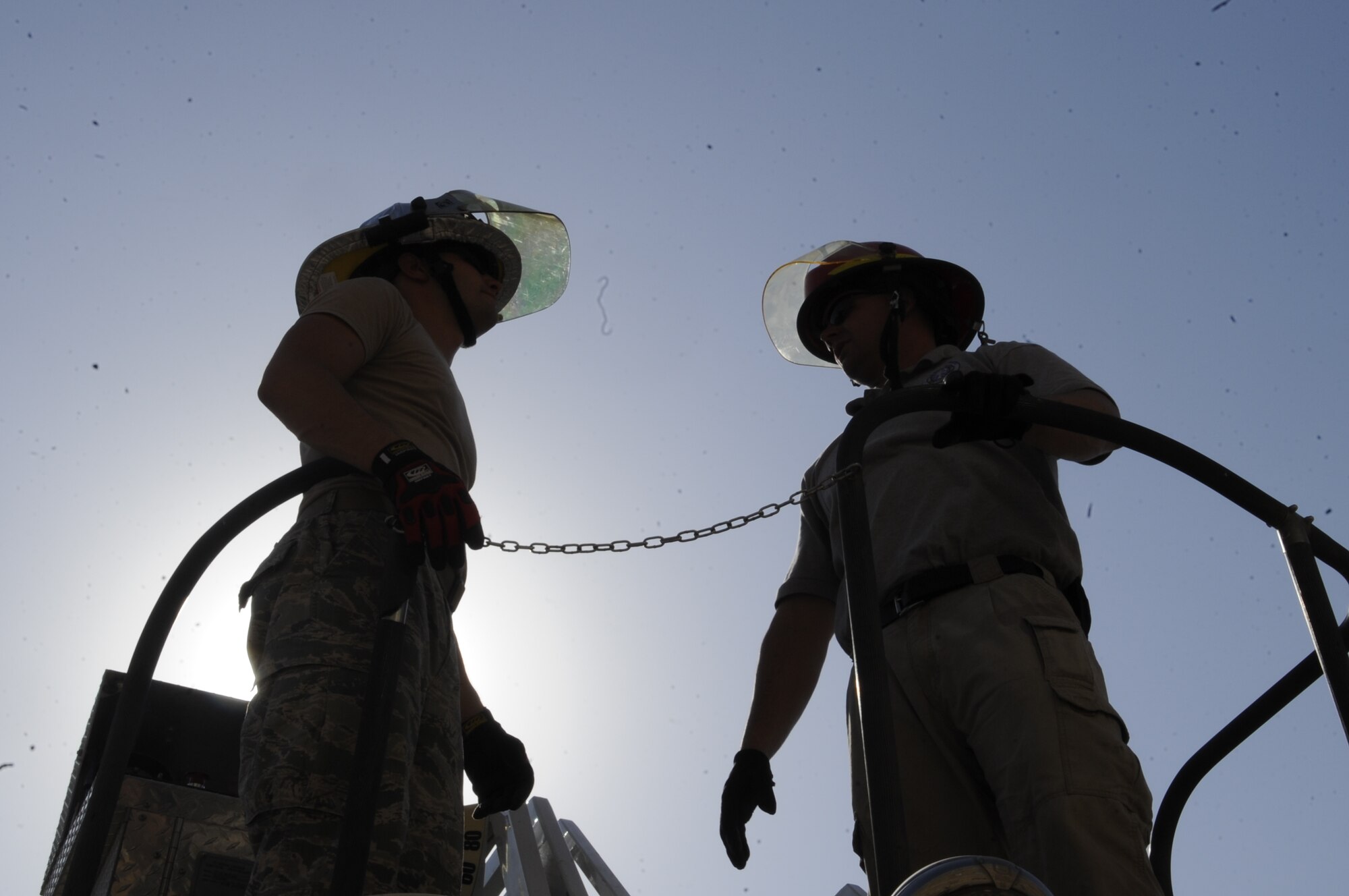 SOUTHWEST ASIA – Senior Airman Jaime Aviles, 386th Expeditionary Civil Engineer Squadron firefighter crew chief, and Joseph Souer, instructor, discusses safety procedures before performing aerial device training here Sept. 28. Firefighters operate the ladder to perform aerial rescue at different levels of a building and requires them to elevate themselves on the ladder to run water from their aerial position. (U.S. Air Force photo/Staff Sgt. Alexandra M. Boutte)
