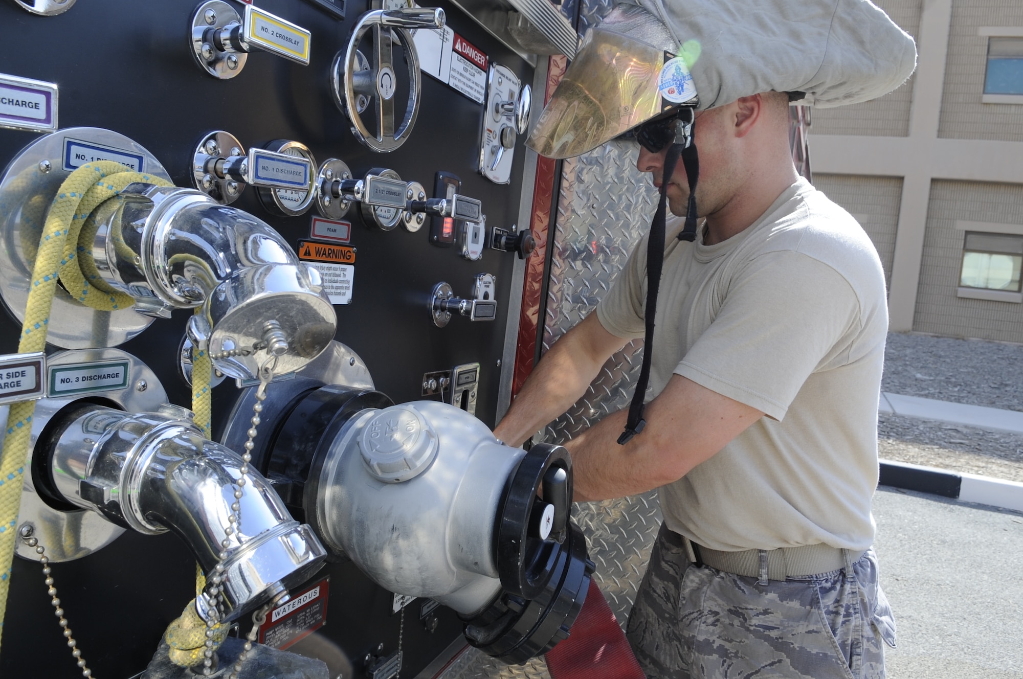 SOUTHWEST ASIA – Staff Sgt. Christopher Wood, 386th Expeditionary Civil Engineer Squadron firefighter crew chief, hooks up a hose in preparation for driver/operator aerial device training here Sept. 28. An aerial device is a ladder truck with water capabilities with elevation. (U.S. Air Force photo/Staff Sgt. Alexandra M. Boutte)