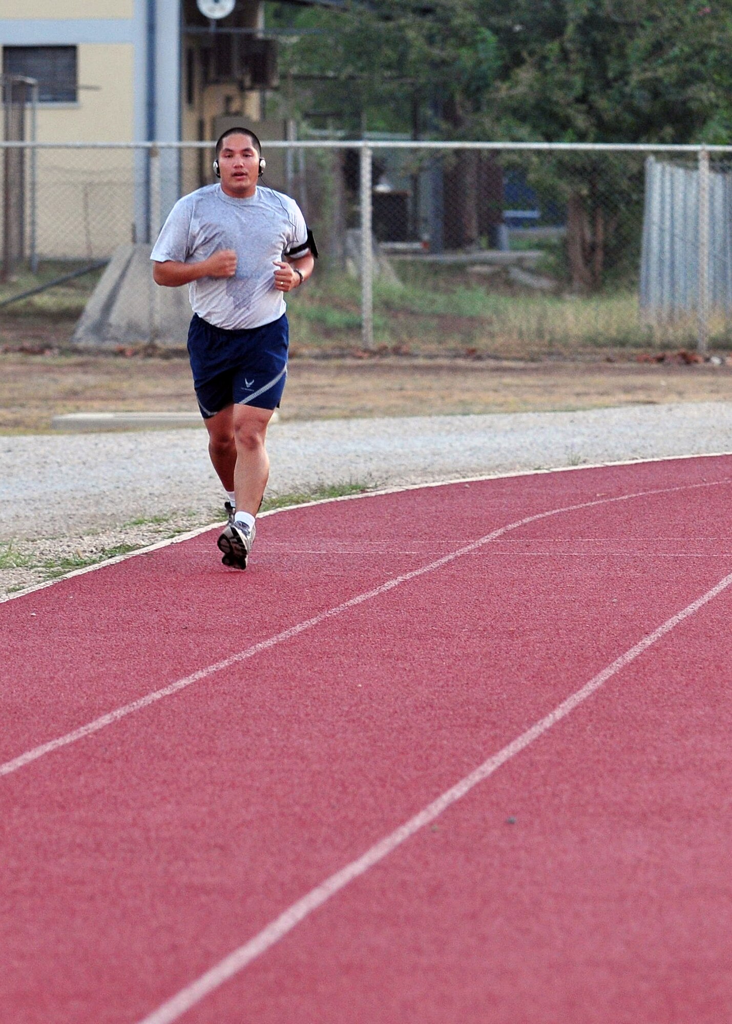 Staff Sgt. Shawn Gumabon, 39th Communications Squadron, paces himself to maintain his heart rate during a lighter interval of the running improvement program at the track Sept. 28, 2012, at Incirlik Air Base, Turkey. The class is designed to help Airmen who scored lower than 45 points on the cardiovascular portion of their fitness assessment tests improve their run time. (U.S. Air Force photo by Senior Airman Daniel Phelps/ Released)