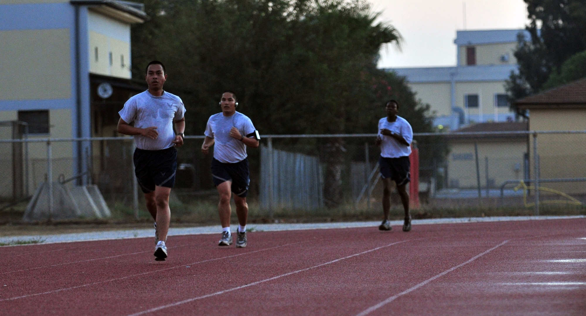 Staff Sgt. Norman Cabrera, 39th Logistics Readiness Squadron, Staff Sgt. Shawn Gumabon, 39th Communications Squadron,  and Tech. Sgt. Janice Batie, 39th LRS, sprint  during the running improvement  program at the track Sept. 28, 2012, at Incirlik Air Base, Turkey. The class is designed to help Airmen who scored lower than 45 points on the cardiovascular portion of their fitness assessment tests improve their run time. (U.S. Air Force photo by Senior Airman Daniel Phelps/ Released)